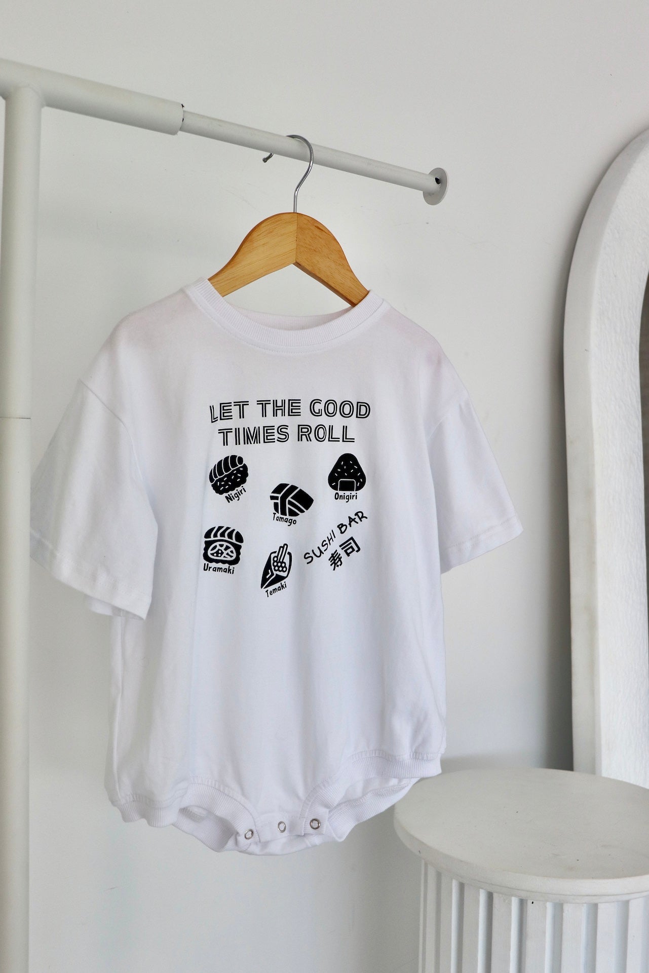 Hanging white oversized romper with a black sushi logo 'Let the good times roll'