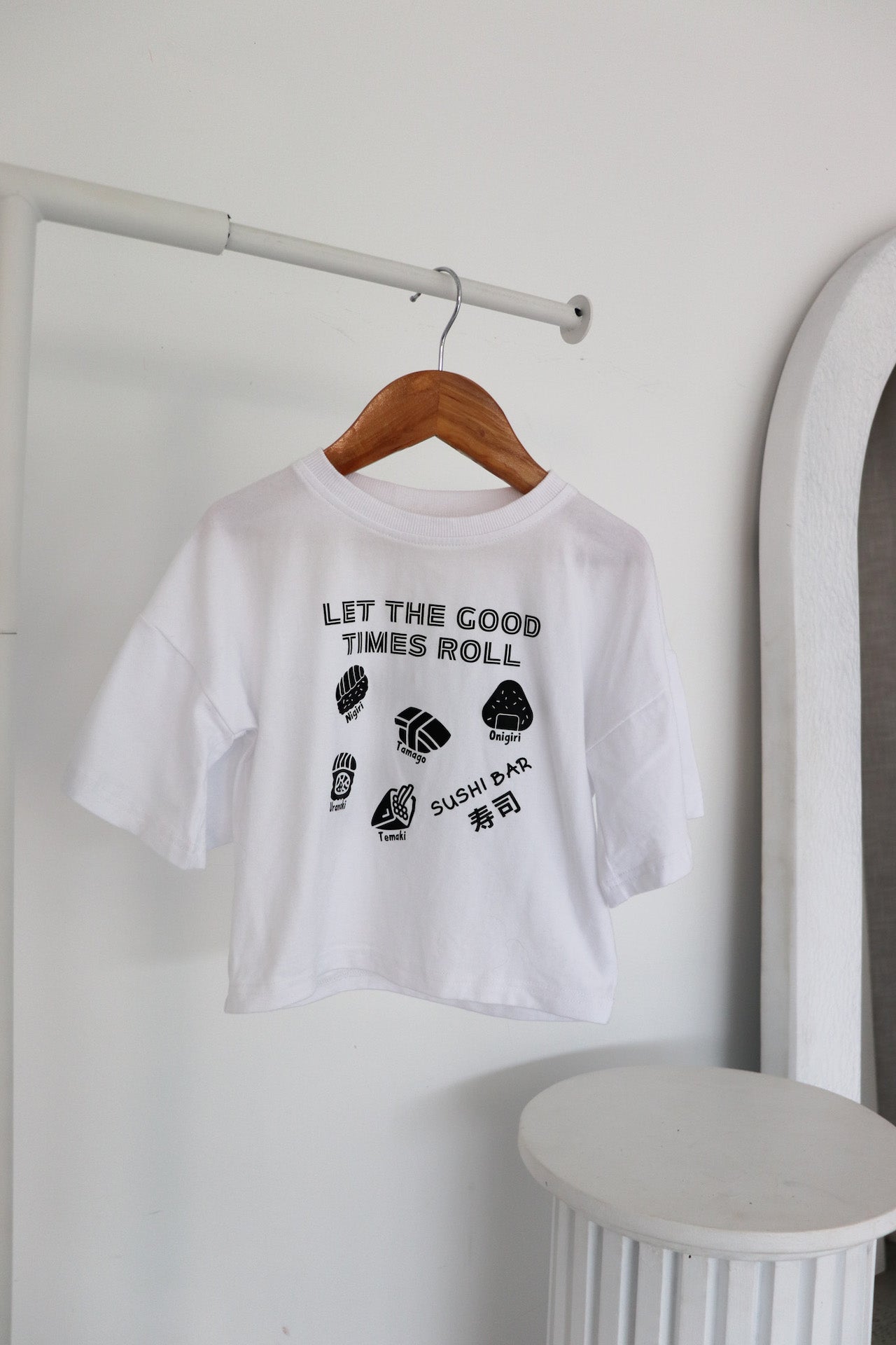 Hanging white oversized t-shirt with a black sushi logo 'Let the good times roll'